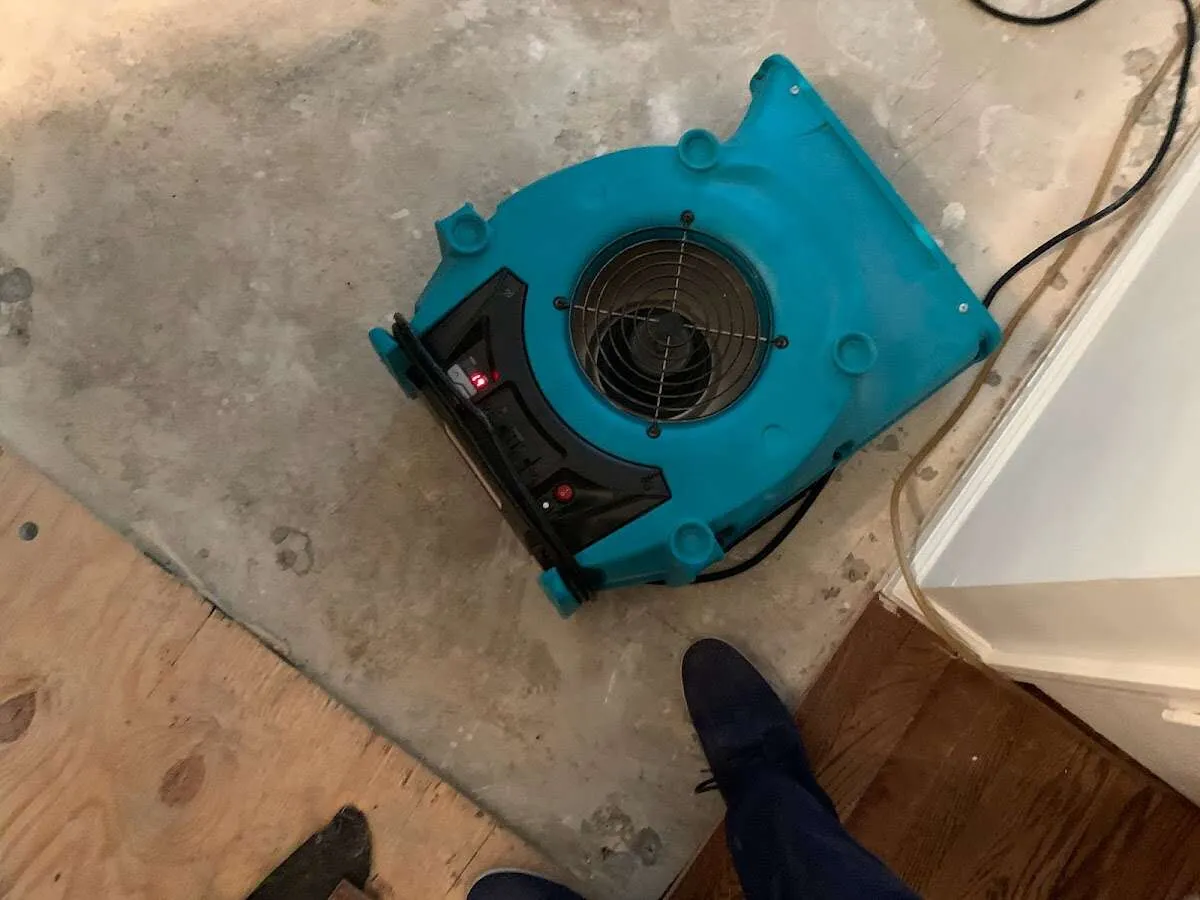 Air mover drying subfloor during Leak Detection & Repair in Bemidji